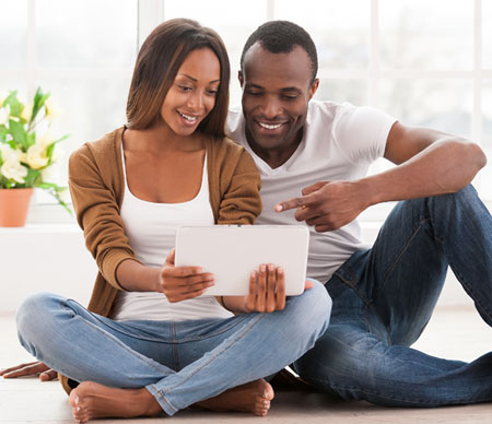 couple on ipad reviewing their household budget